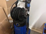 a blue and black vacuum and some boxes in a room