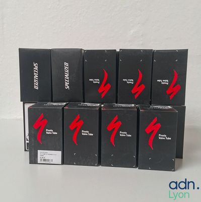 six boxes of black and red lipstick sitting on top of a white table