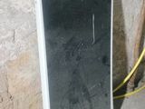 a mirror that is sitting on the ground next to a wall