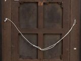 an old wooden door with a chain hanging from it ' s side