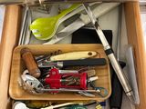 a drawer full of kitchen utensils and tools