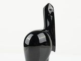a black vase with a bird on it on a white surface