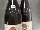 three bottles of wine are sitting on a glass table