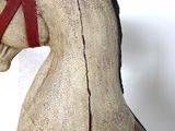 a wooden horse with a harness on it ' s head