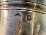 a close up of a silver cup on a table