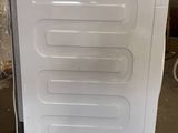 an image of a white refrigerator in a warehouse