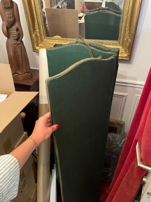 someone is holding a mirror in front of a mirror in a room