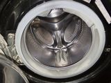 a close up of a washing machine with a lot of money inside of it