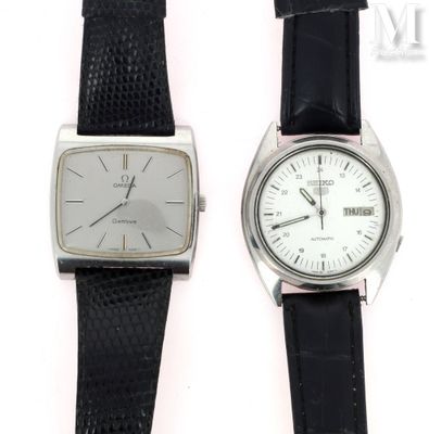 two watches sitting next to each other on a white surface