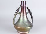 a metallic vase with a handle on a white background