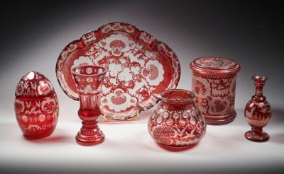 de nombreux objets en verre rouges et blancs posés sur une table