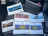 a lot of car brochures on the back seat of a car
