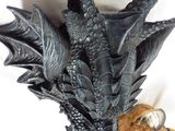 a statue of a dragon head with a tiger behind it