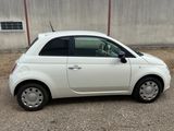a small white car parked in front of a building