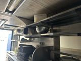 many plates and pans on the shelves in the kitchen