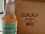 a bottle of liquid sitting on a table next to a box