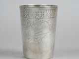 a silver cup that is sitting on a table