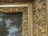 an image of a picture of a painting in a gold frame on a table