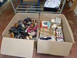 two boxes of shoes that are sitting on the floor