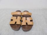 a close up of a pair of sandals on a bed
