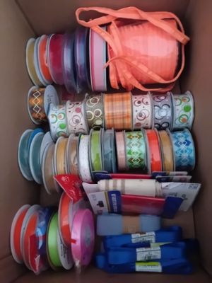 a box full of different types of ribbons in it
