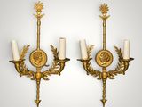 a pair of antique wall sconces with gold leaf decoration