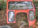 a red bus that is sitting in the grass