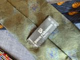 a close up of a tie with a tag on it