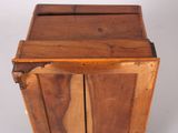 a small wooden cabinet with two doors on it