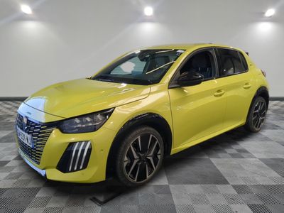 a yellow car parked in a garage with a checkered floor