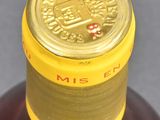 a close up of a bottle of alcohol on a table
