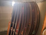 a lot of wooden boards stacked on top of each other in a room