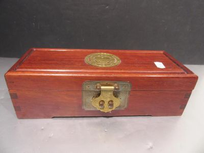an old wooden box with a brass lock on top of it
