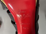 the bottom of a pair of red high heeled shoes with a gold heel