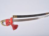 a picture of a sword with a red tassel on it