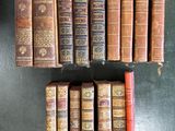 several old books are stacked on top of each other on a table