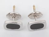 two pairs of black stone cufflinks on a white background