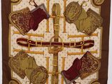 a close up of a brown and gold scarf with boots on it