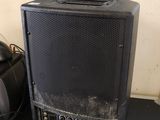 a speaker that is sitting on top of a shelf
