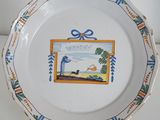 a plate with a picture of a man and a dog on it