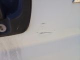 a close up of a door handle on a white car