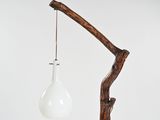 an image of a light bulb hanging from a wooden branch