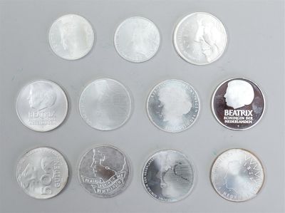 several coins are arranged in a row on a gray surface