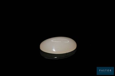a white mouse sitting on top of a black surface