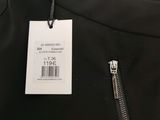a close up of a black jacket with a tag on it