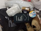 a pile of clothes and other items on a bed
