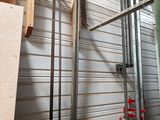 a metal rack with tools hanging on it in a garage