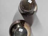 two cups that are sitting on a table