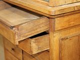 a close up of a wooden dresser with a glass top