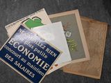 a pile of old french postcards on a table